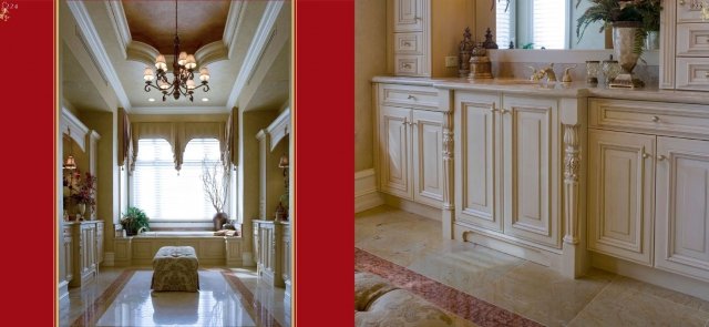 This picture shows a luxurious modern kitchen with a white and gold themed design. The cabinet fronts with gold detailing and an island countertop with marble and gold accents are the main features of the design. There is a built-in refrigerator with panel doors, a stove top, and a sink. On the island counter, there are several accessories, including a hanging pot rack, wall-mounted spice racks, and a vase with flowers. The high-end appliances and materials used create an elegant and sophisticated ambience.