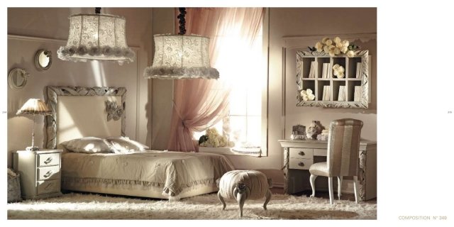 This picture shows a luxury living room featuring two cream-colored armchairs with gold accents, a red and grey accent chair, a gray sofa, and a black and white patterned rug. There is a large wall mirror with a gold frame and an art piece above it, as well as a modern gold lamp and several other decorative pieces. The floor is made of light-colored wood, which adds to the warm atmosphere of the room.