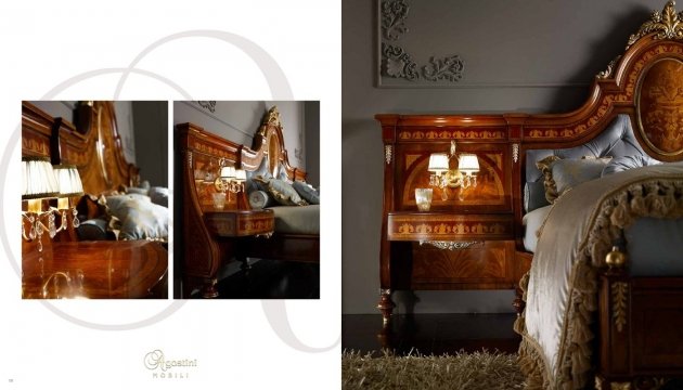 This picture is of a luxurious and stylish dining room. The room features an ornately carved wooden table with elegant white chairs upholstered in velvet fabric. A beautiful, dark wood sideboard stands against the back wall, and a grand crystal chandelier illuminates the space. The walls and ceiling have been intricately painted with gold and cream accents. The floor is covered with a rich, beige carpet, and large windows adorned with drapes provide a warm, inviting atmosphere.