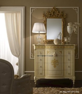 This picture shows a luxurious, modern living room with a stylish white and gray color scheme. The room features a large gray sofa with several accent pillows, a black and white abstract wall art, a white marble side table, and a white shelving unit with an ornate gold frame. The room also has a large white wooden floor, plenty of windows to bring in natural light, and a crystal chandelier for added sophistication.