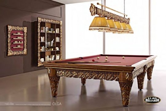 This picture depicts an ornate, luxurious bathroom with a black and white marbled floor, three walls lined with white brick tiles, and a fourth wall centered with a vanity featuring two mirrors above a floating marble countertop with two sink basins. Above the vanity is a large crystal chandelier and several recessed spotlights in the ceiling. On the left side of the room is a corner shower stall with a glass door, and on the right side is a large soaking tub with a gold-plated faucet.