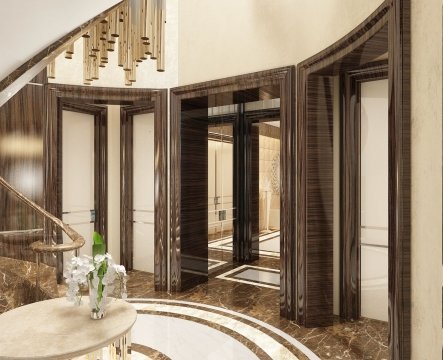 Glorious bathroom decor featuring a high ceiling, a white marble countertop, elegant urns and intricate gold fixtures.