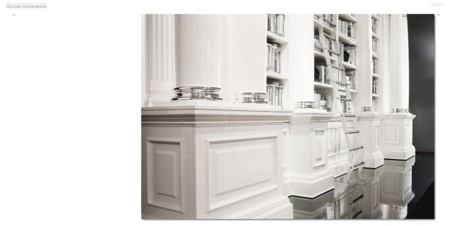 This picture shows a luxurious modern bathroom. It consists of a large shower area, double marble basins and a bathtub with a built-in waterfall feature. The walls and floor are covered in light colored marble, while the walls and ceiling are painted in a neutral color. A large mirror is mounted on one wall, and a beautiful chandelier hangs from the ceiling. The room is decorated with white towels, an ornate vase and a plant in the corner.