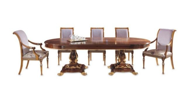 Elegant Oval table with walnut feather top and gilded details.
