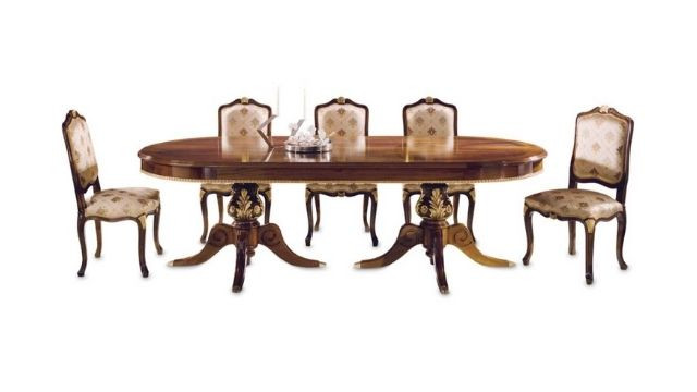 Elegant Oval table with walnut feather top, and gold carved bases
